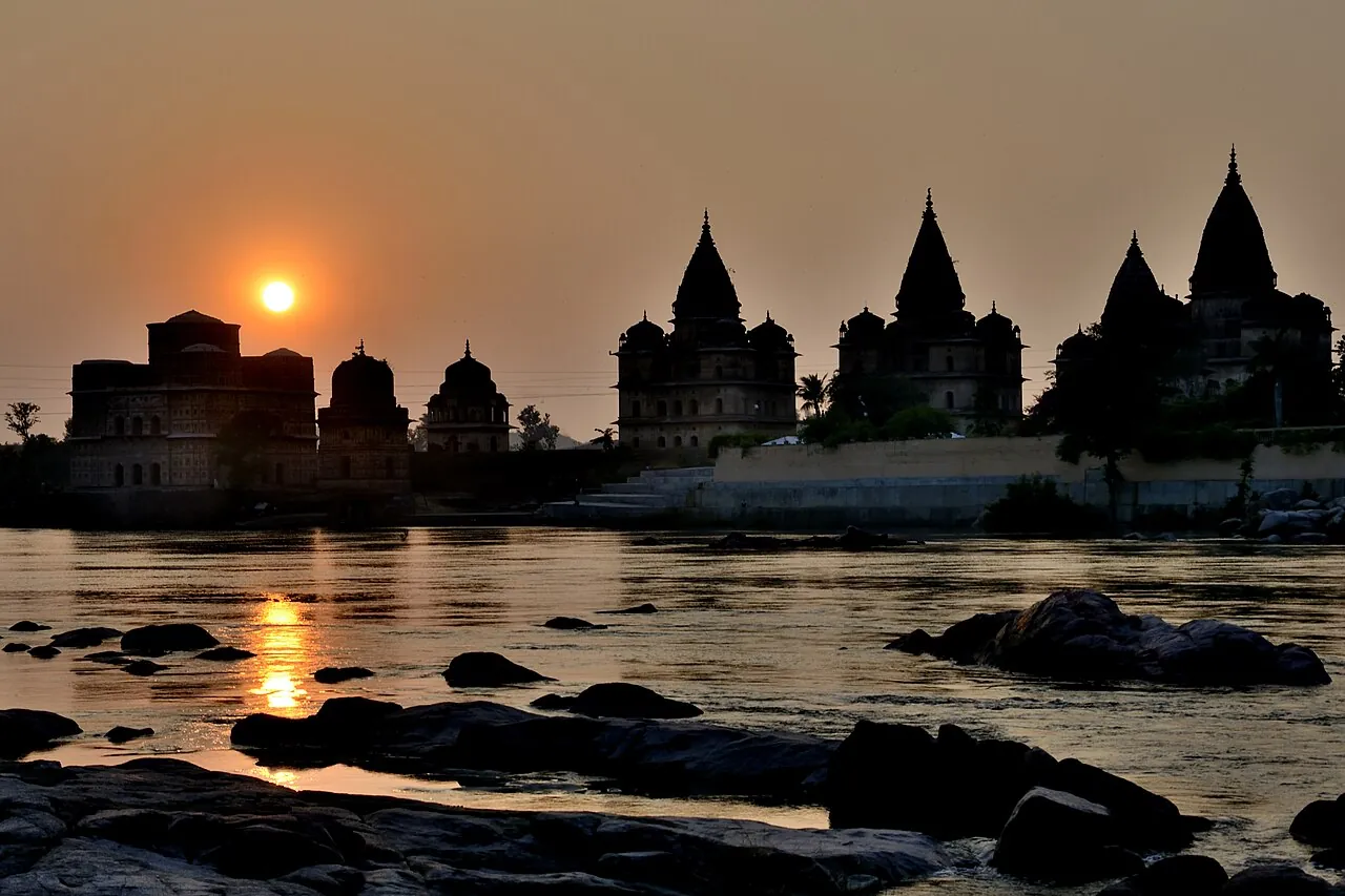 Royal chhatris beside the Betwa River in Orchha at sunset